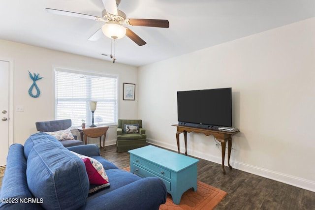 living area featuring baseboards, ceiling fan, and wood finished floors