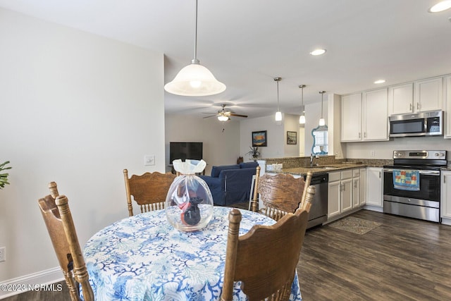 dining room featuring baseboards, dark wood-style flooring, a ceiling fan, and recessed lighting