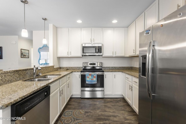 kitchen featuring stainless steel appliances, white cabinets, recessed lighting, and a sink