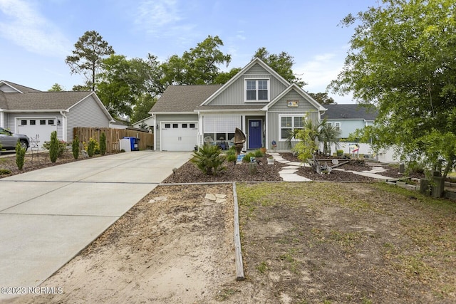 craftsman inspired home with concrete driveway, fence, and a garage