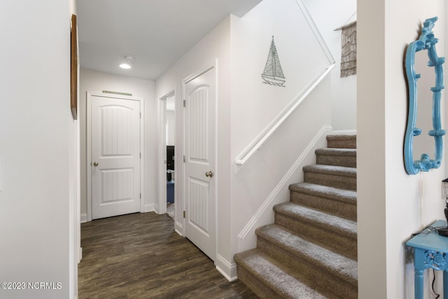 stairway featuring baseboards and wood finished floors