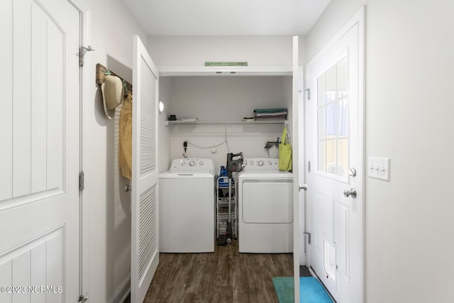 washroom with washer and dryer, laundry area, and wood finished floors