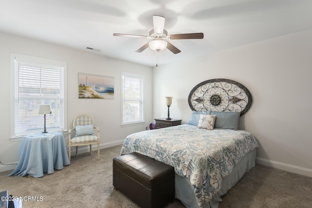 carpeted bedroom featuring visible vents, baseboards, and a ceiling fan