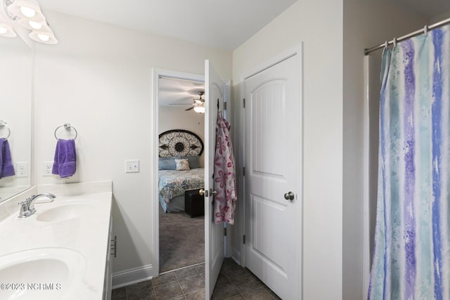 full bath featuring double vanity, a sink, tile patterned flooring, ceiling fan, and ensuite bath
