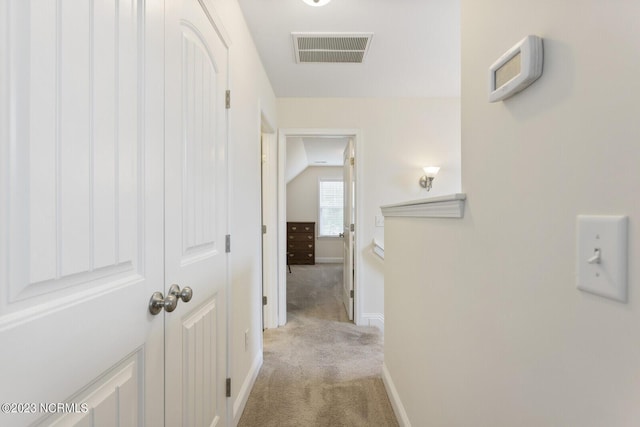 corridor with baseboards, carpet flooring, and visible vents