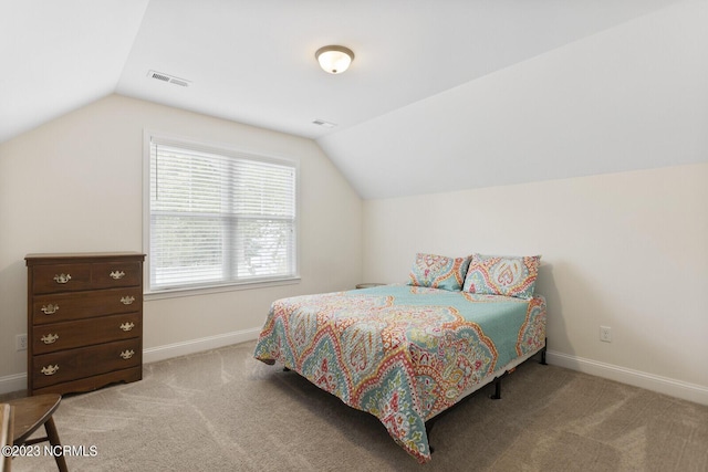 carpeted bedroom with visible vents, baseboards, and lofted ceiling