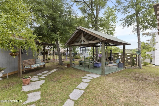 view of yard with fence, a gazebo, and a deck