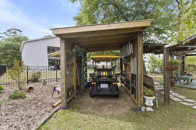 view of patio with fence and a carport