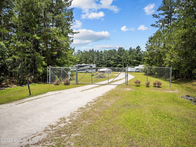 210 Sumter Ct, Havelock, NC 28532 - view of road with a gate, a gated entry, and a forest view