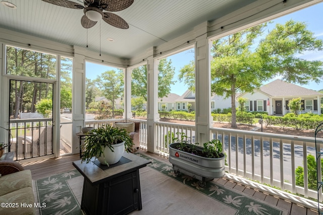 9298 W Lake Rd, Calabash, NC 28467 - sunroom / solarium with a wealth of natural light, a residential view, and ceiling fan