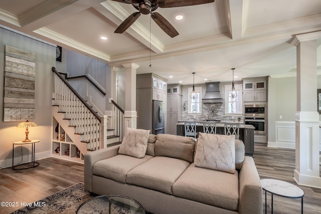 9298 W Lake Rd, Calabash, NC 28467 - living room featuring ceiling fan, decorative columns, stairs, crown molding, and beam ceiling