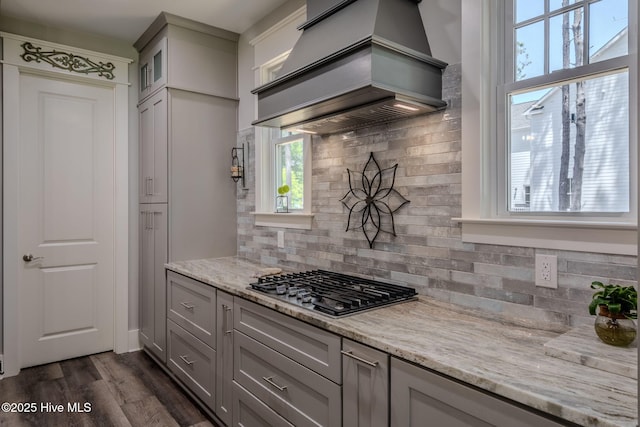 9298 W Lake Rd, Calabash, NC 28467 - kitchen featuring stainless steel gas stovetop, gray cabinetry, decorative backsplash, and custom range hood