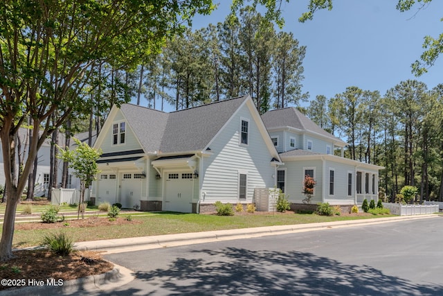 9298 W Lake Rd, Calabash, NC 28467 - view of front facade with a shingled roof, a garage, and fence