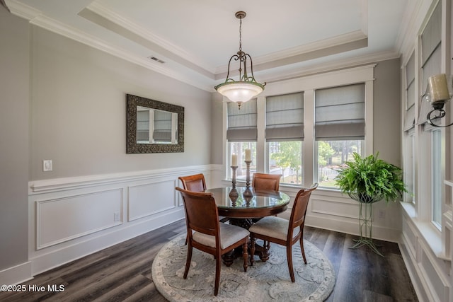 9298 W Lake Rd, Calabash, NC 28467 - dining area with a raised ceiling, visible vents, a wainscoted wall, and dark wood-type flooring