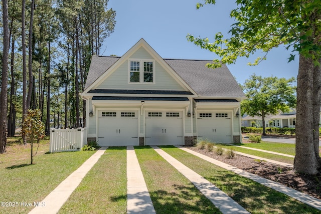 9298 W Lake Rd, Calabash, NC 28467 - exterior space featuring a shingled roof, a garage, and a front yard