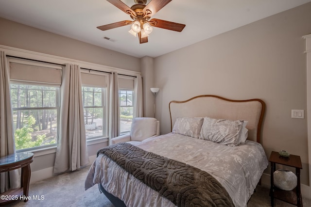 9298 W Lake Rd, Calabash, NC 28467 - carpeted bedroom featuring ceiling fan, baseboards, visible vents, and multiple windows