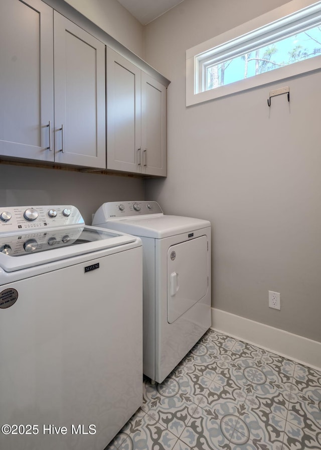 9298 W Lake Rd, Calabash, NC 28467 - clothes washing area featuring washing machine and dryer, cabinet space, baseboards, and light tile patterned floors