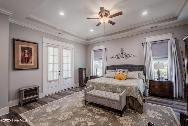 9298 W Lake Rd, Calabash, NC 28467 - bedroom with a tray ceiling, multiple windows, wood finished floors, and ornamental molding