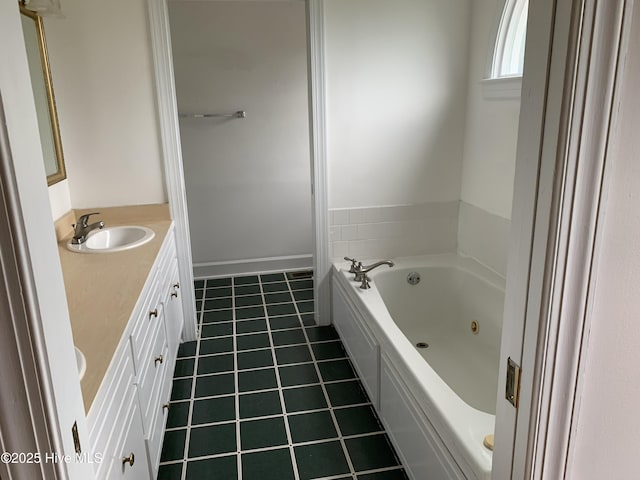 full bathroom featuring tile patterned floors, vanity, and a jetted tub