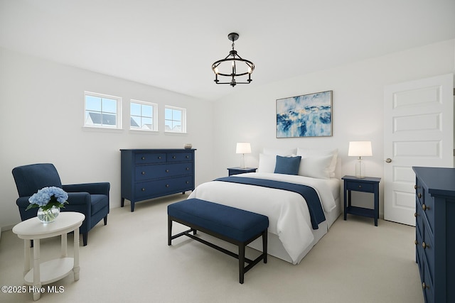 bedroom with light carpet and a notable chandelier