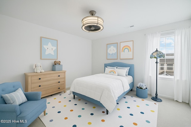 bedroom featuring light colored carpet, visible vents, and baseboards
