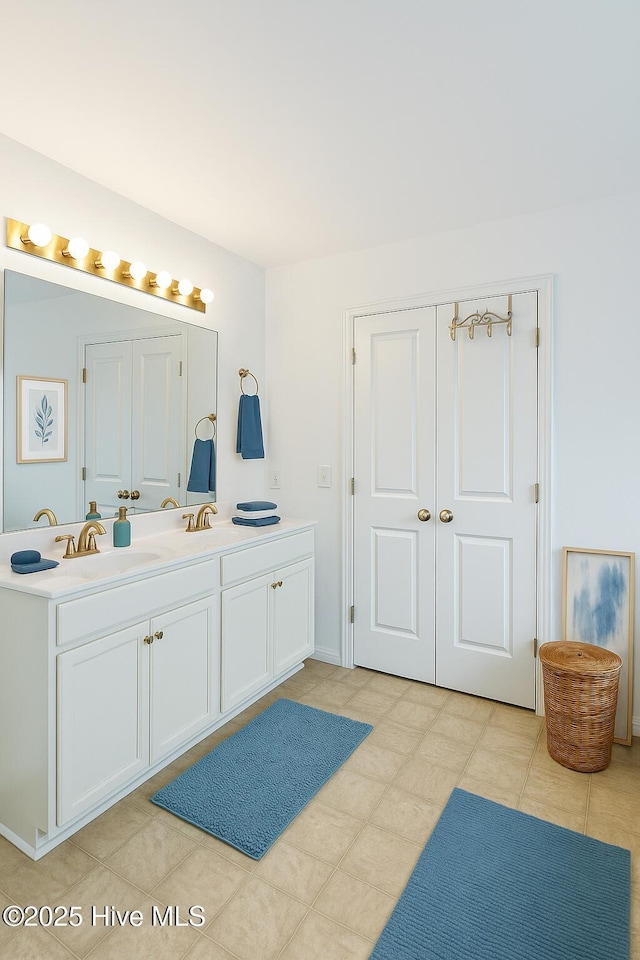 bathroom featuring tile patterned floors, double vanity, and a sink