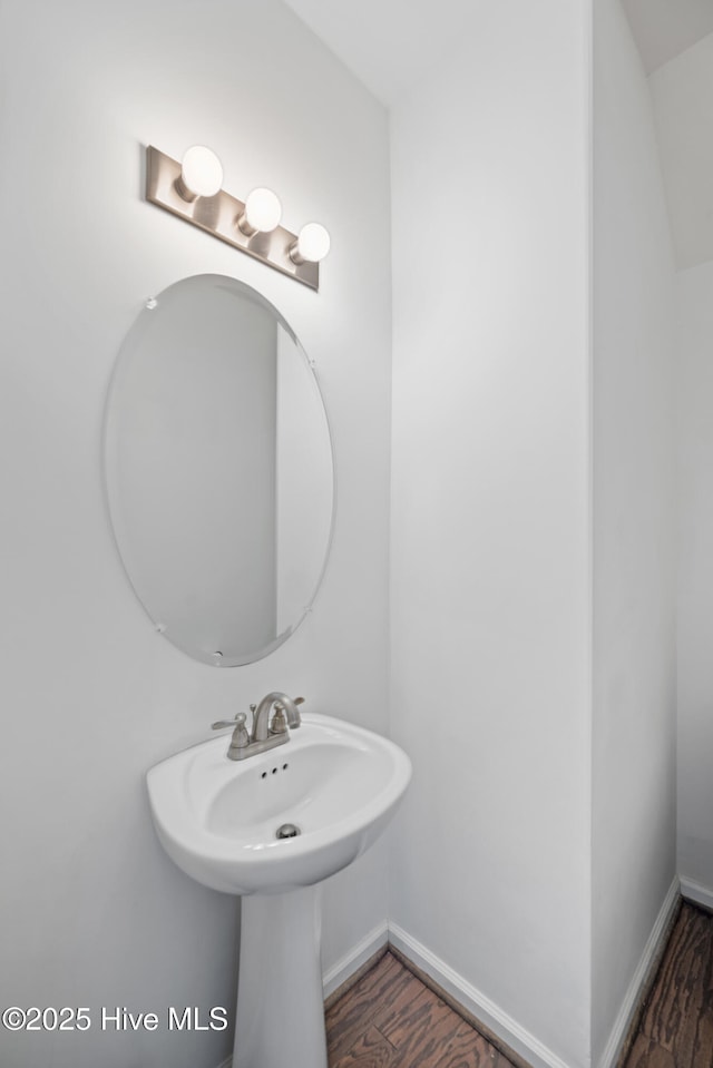 bathroom featuring baseboards and wood finished floors