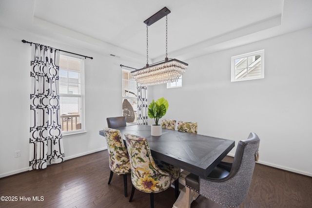 dining space with baseboards, a healthy amount of sunlight, and wood finished floors