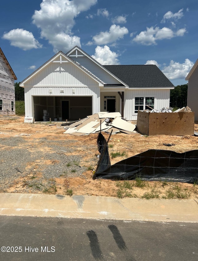 506 Grassy Gap Trl Unit 70, Aberdeen, NC 28315 - view of front of home featuring board and batten siding, an attached garage, and roof with shingles