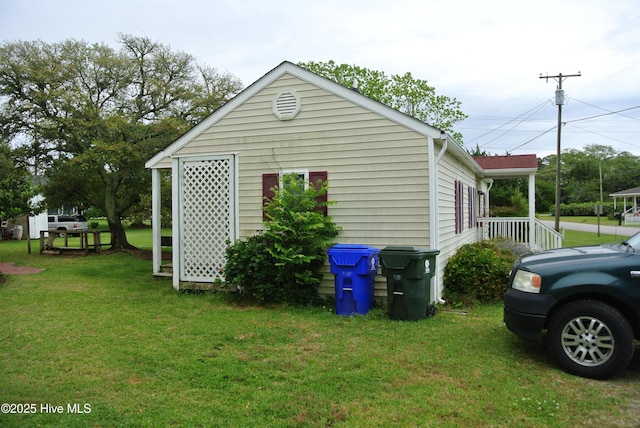 view of side of home featuring a lawn