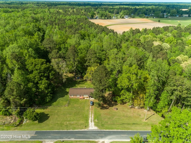 drone / aerial view with a wooded view