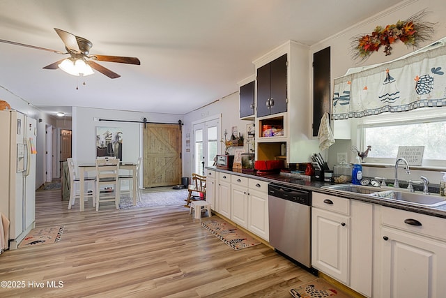 kitchen with dishwasher, white refrigerator with ice dispenser, a sink, and dark countertops