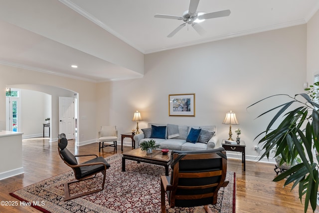 8819 Sawmill Creek Ln, Wilmington, NC 28411 - living room featuring arched walkways, a ceiling fan, ornamental molding, baseboards, and wood finished floors