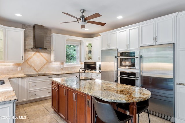 8819 Sawmill Creek Ln, Wilmington, NC 28411 - kitchen with appliances with stainless steel finishes, a sink, wall chimney exhaust hood, ceiling fan, and white cabinetry