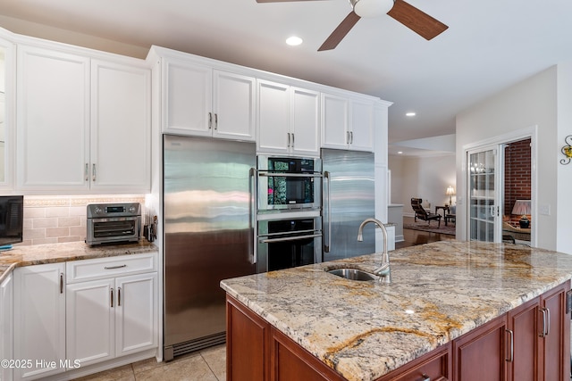 8819 Sawmill Creek Ln, Wilmington, NC 28411 - kitchen featuring appliances with stainless steel finishes, a sink, a ceiling fan, white cabinets, and recessed lighting