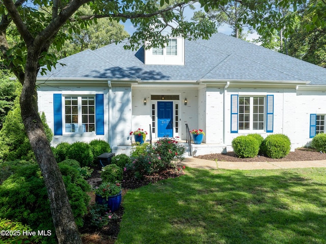 8819 Sawmill Creek Ln, Wilmington, NC 28411 - view of front of property with brick siding, roof with shingles, a front lawn, and a porch