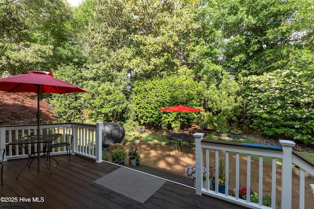 8819 Sawmill Creek Ln, Wilmington, NC 28411 - wooden deck with outdoor dining area, a grill, and a forest view