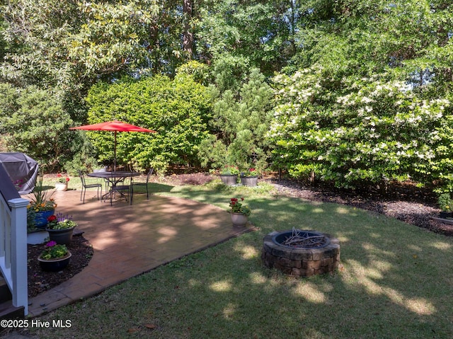8819 Sawmill Creek Ln, Wilmington, NC 28411 - view of grassy yard featuring a patio and a fire pit