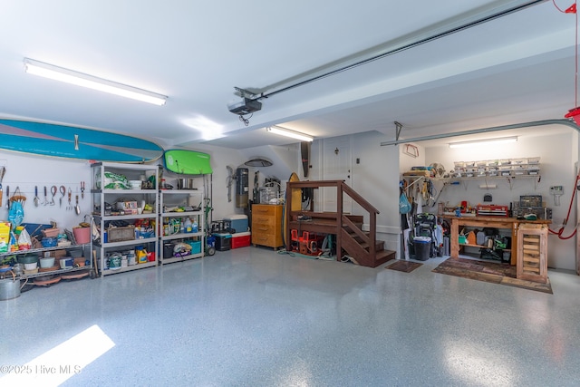 8819 Sawmill Creek Ln, Wilmington, NC 28411 - garage featuring a workshop area, a garage door opener, and a central vacuum unit