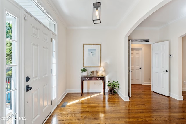 8819 Sawmill Creek Ln, Wilmington, NC 28411 - foyer entrance with arched walkways, wood finished floors, crown molding, and baseboards