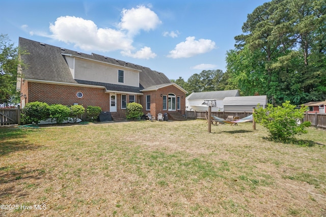 107 Magnolia Dr, Camden, NC 27921 - back of property with entry steps, brick siding, and roof with shingles