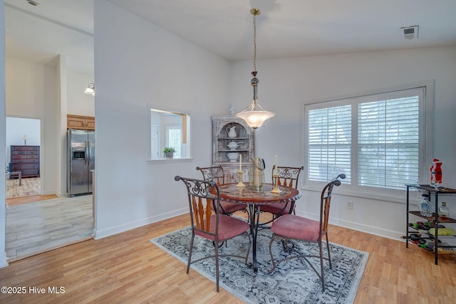 5029 Woods Edge Rd, Wilmington, NC 28409 - dining room featuring a high ceiling, visible vents, baseboards, and light wood-type flooring