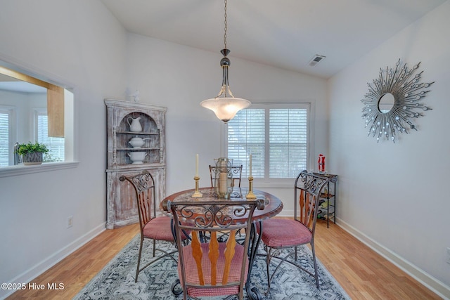 5029 Woods Edge Rd, Wilmington, NC 28409 - dining area featuring lofted ceiling, visible vents, light wood finished floors, and baseboards