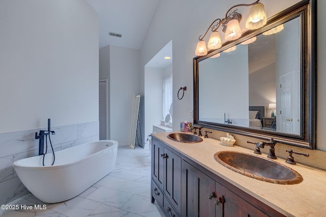 5029 Woods Edge Rd, Wilmington, NC 28409 - ensuite bathroom with visible vents, a freestanding bath, marble finish floor, and a sink
