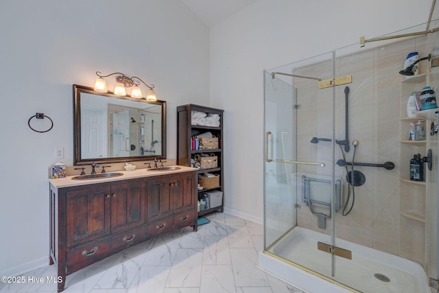 5029 Woods Edge Rd, Wilmington, NC 28409 - bathroom featuring a stall shower, marble finish floor, double vanity, and a sink