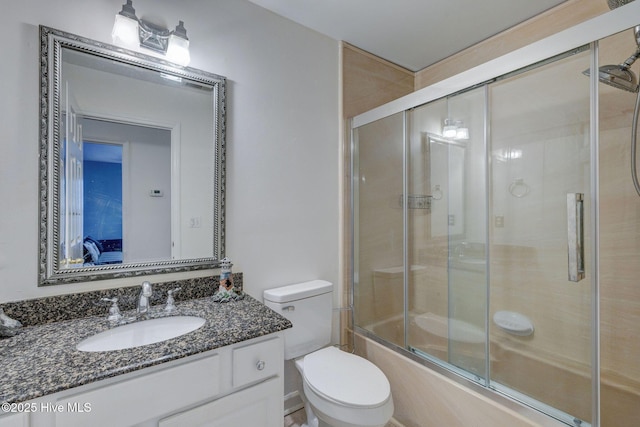 5029 Woods Edge Rd, Wilmington, NC 28409 - bathroom with combined bath / shower with glass door, vanity, and toilet