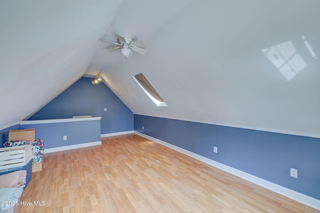 5029 Woods Edge Rd, Wilmington, NC 28409 - additional living space featuring a ceiling fan, vaulted ceiling with skylight, wood finished floors, and baseboards