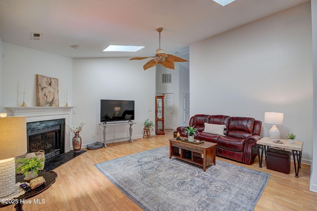 5029 Woods Edge Rd, Wilmington, NC 28409 - living area featuring wood finished floors, a premium fireplace, a ceiling fan, and visible vents