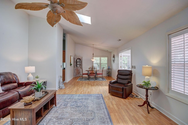5029 Woods Edge Rd, Wilmington, NC 28409 - living area featuring lofted ceiling with skylight, visible vents, light wood-type flooring, and baseboards