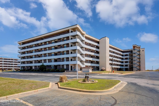 view of building exterior with uncovered parking